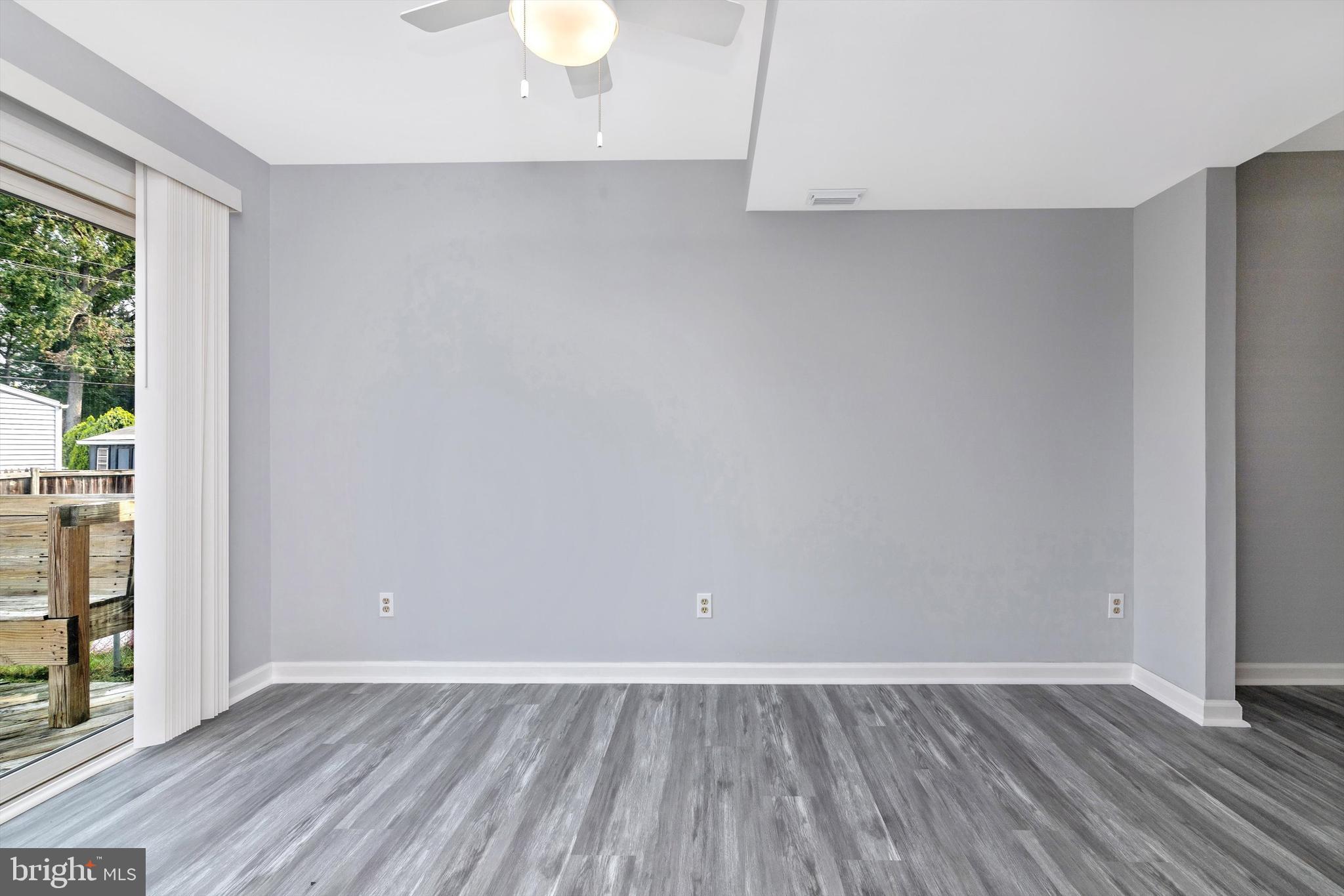 1702 Potomac Road Edgewater, MD 21037 - Photo 31 of 41 a view of an empty room with wooden floor and a window