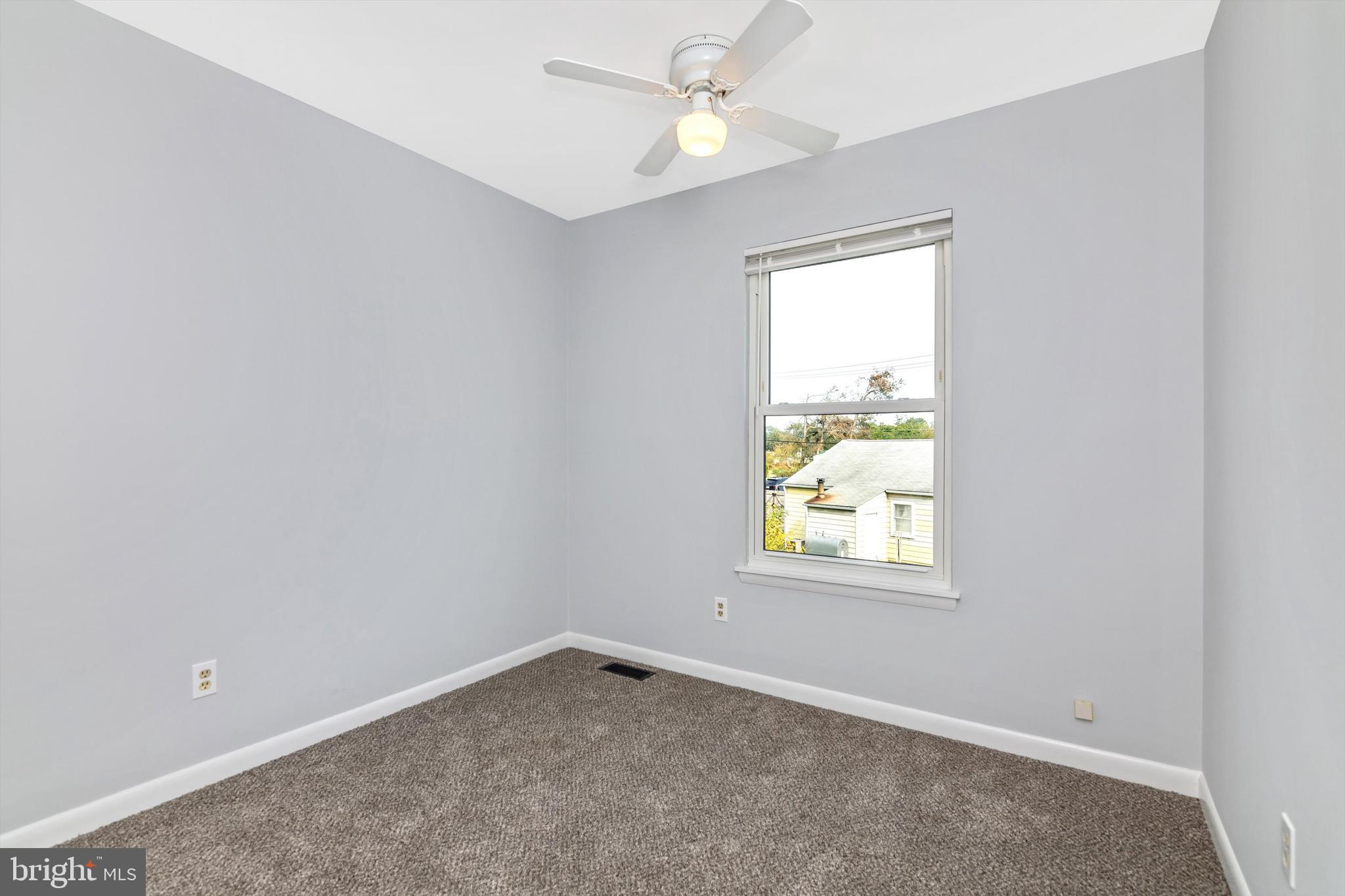 1702 Potomac Road Edgewater, MD 21037 - Photo 36 of 41 an empty room with a window and a fan