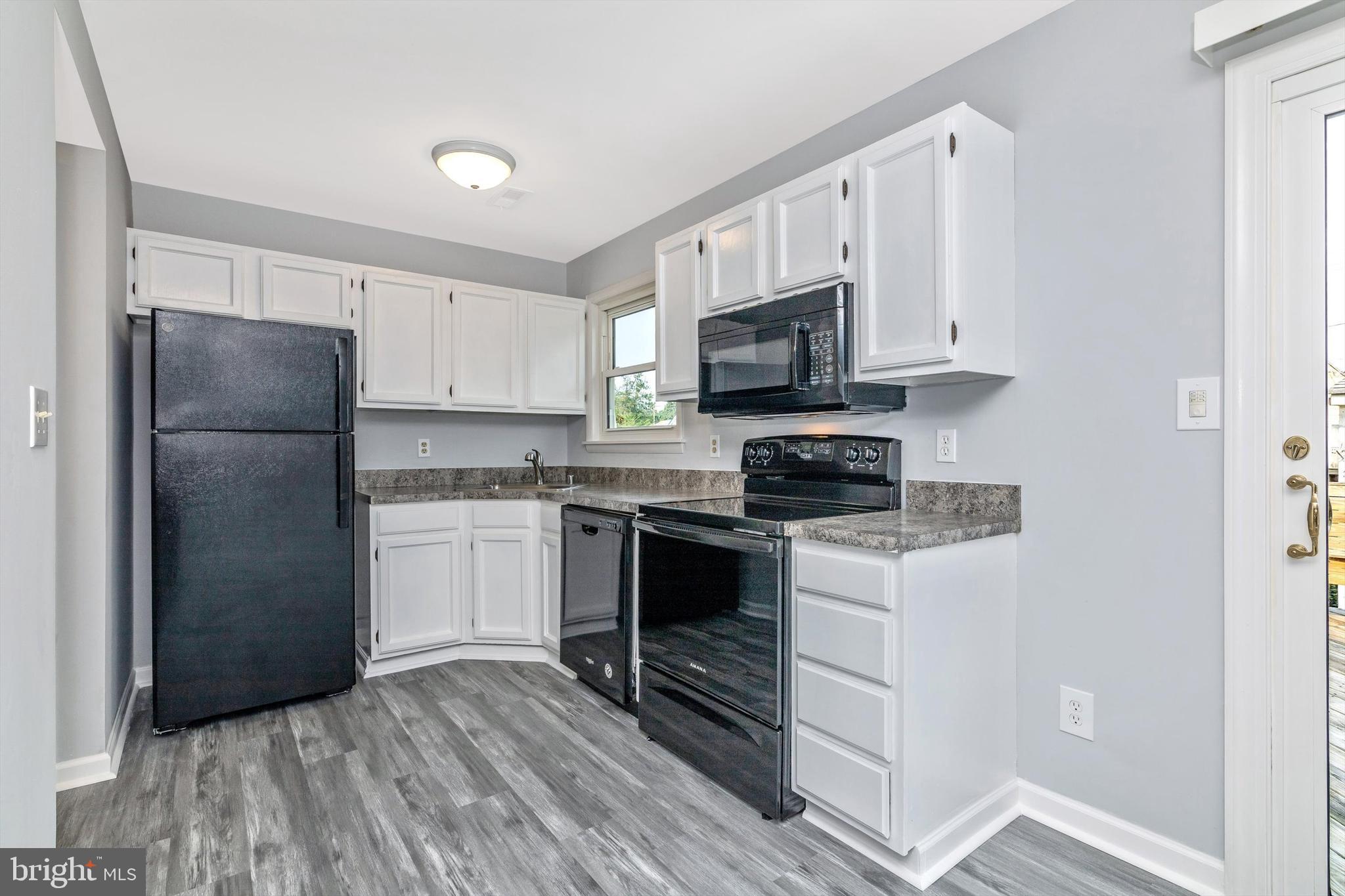 1702 Potomac Road Edgewater, MD 21037 - Photo 6 of 41 a kitchen with a refrigerator stove and microwave