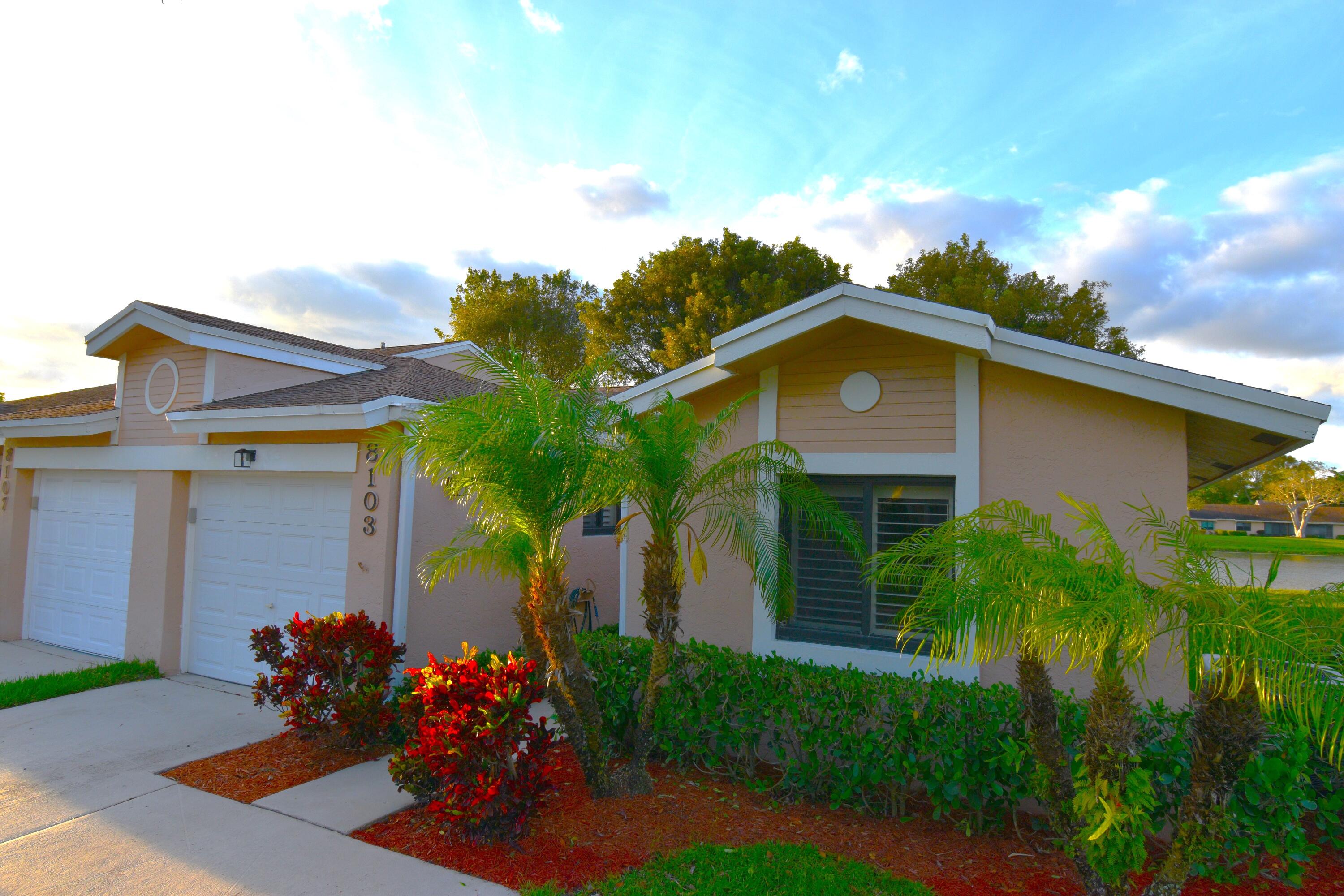 8103 Songbird Terrace Boca Raton, FL 33496 - Photo 1 of 39 a front view of a house with a yard