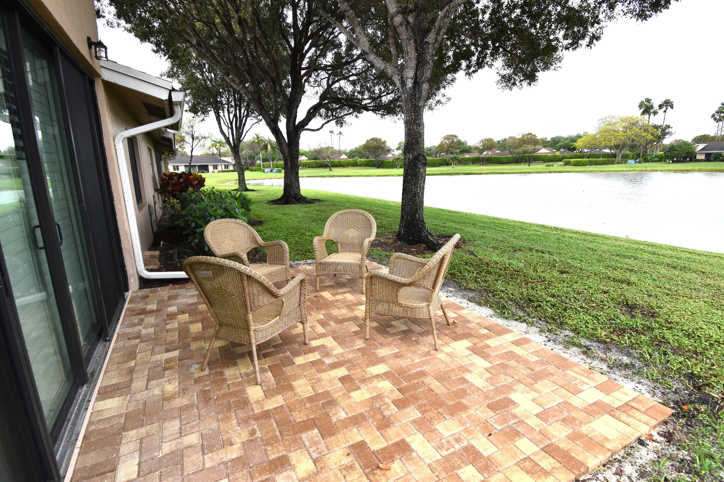 8103 Songbird Terrace Boca Raton, FL 33496 - Photo 14 of 39 a view of outdoor space with seating area and garden