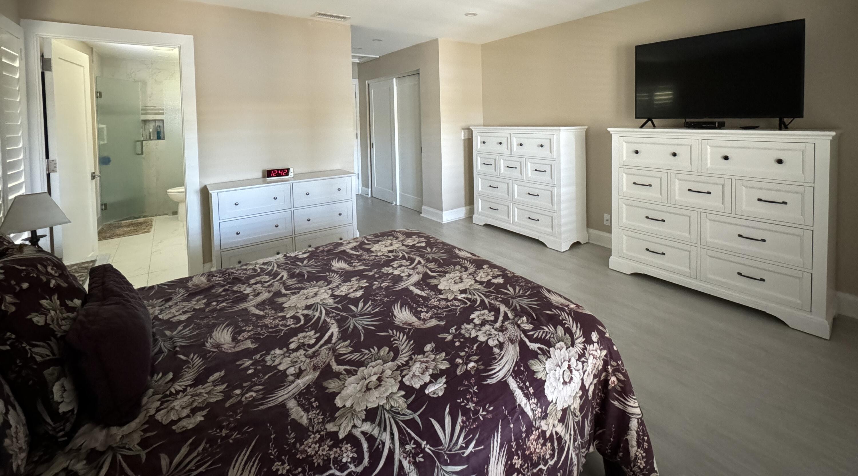 8103 Songbird Terrace Boca Raton, FL 33496 - Photo 20 of 39 a bedroom with a bed and flat screen tv