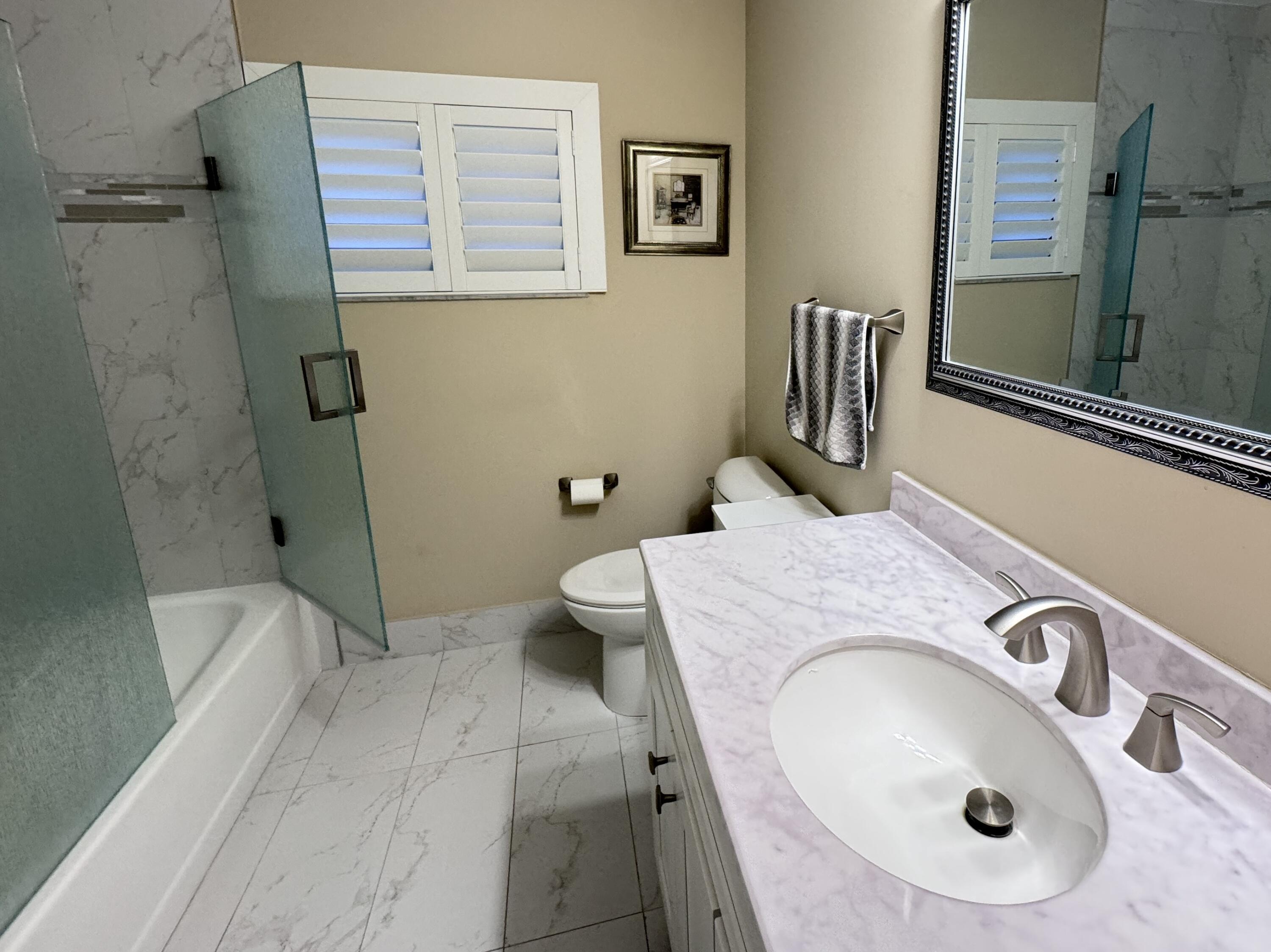 8103 Songbird Terrace Boca Raton, FL 33496 - Photo 23 of 39 a bathroom with a sink and mirror