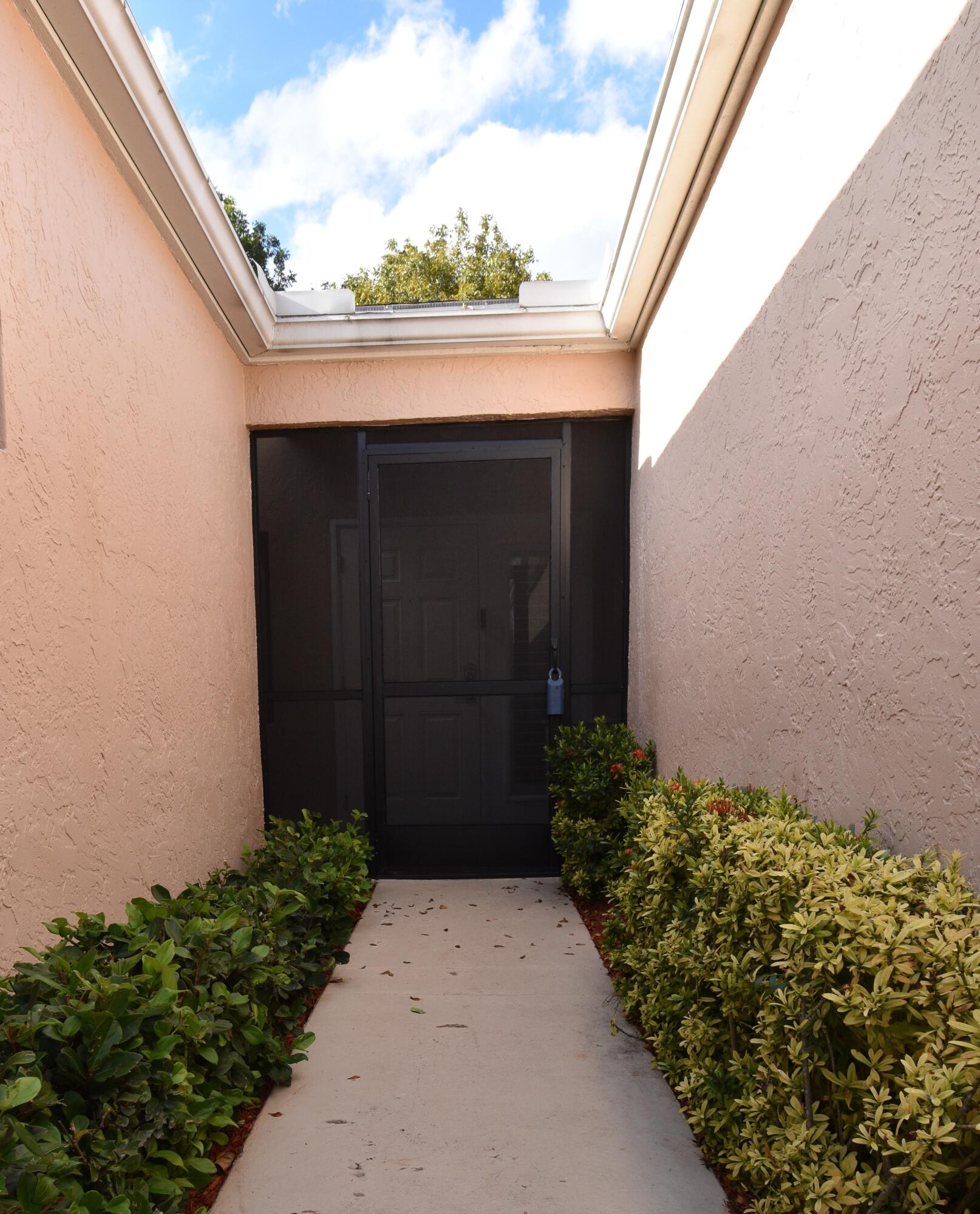 8103 Songbird Terrace Boca Raton, FL 33496 - Photo 2 of 39 a couple of flower plants in front of door