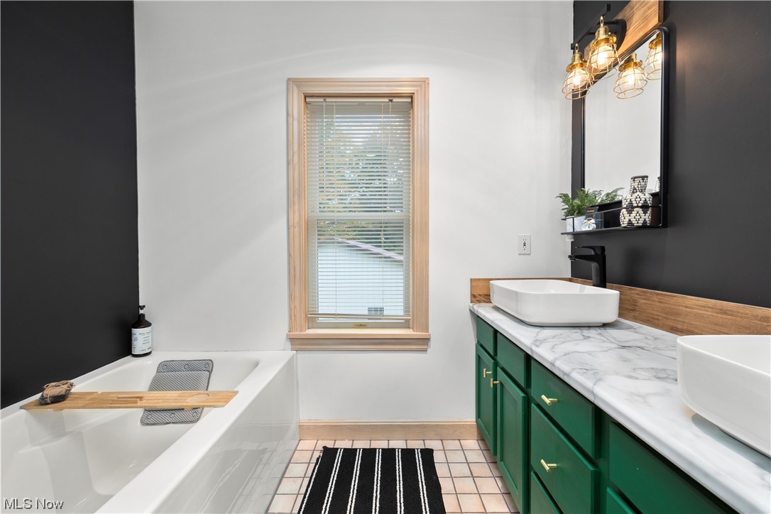 2097 Butler Road Wakeman, OH 44889 - Photo 24 of 34 Bathroom featuring a bathtub, tile flooring, and dual vanity