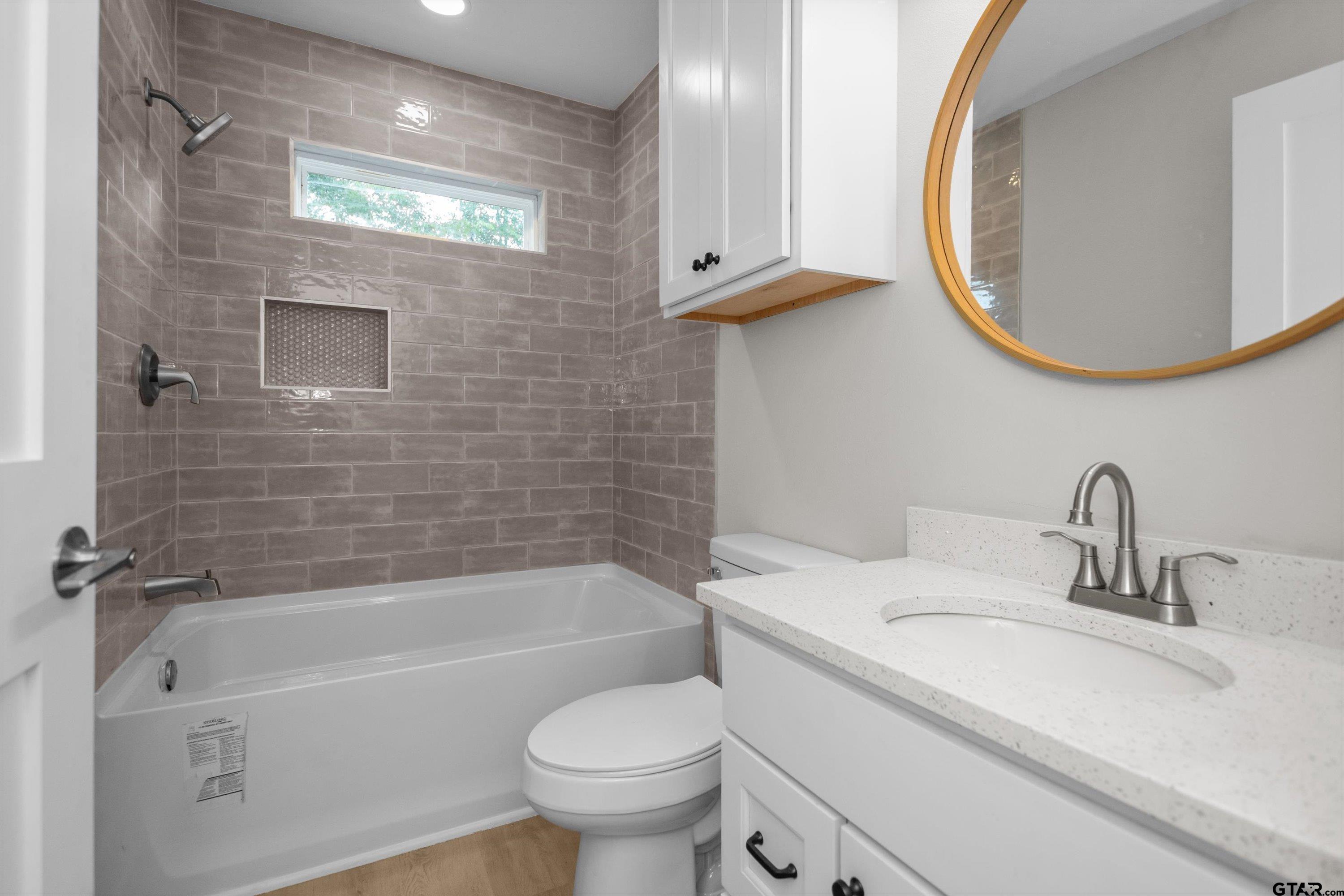 601 North 4th Street Crockett, TX 75835 - Photo 16 of 25 a bathroom with a sink and a mirror
