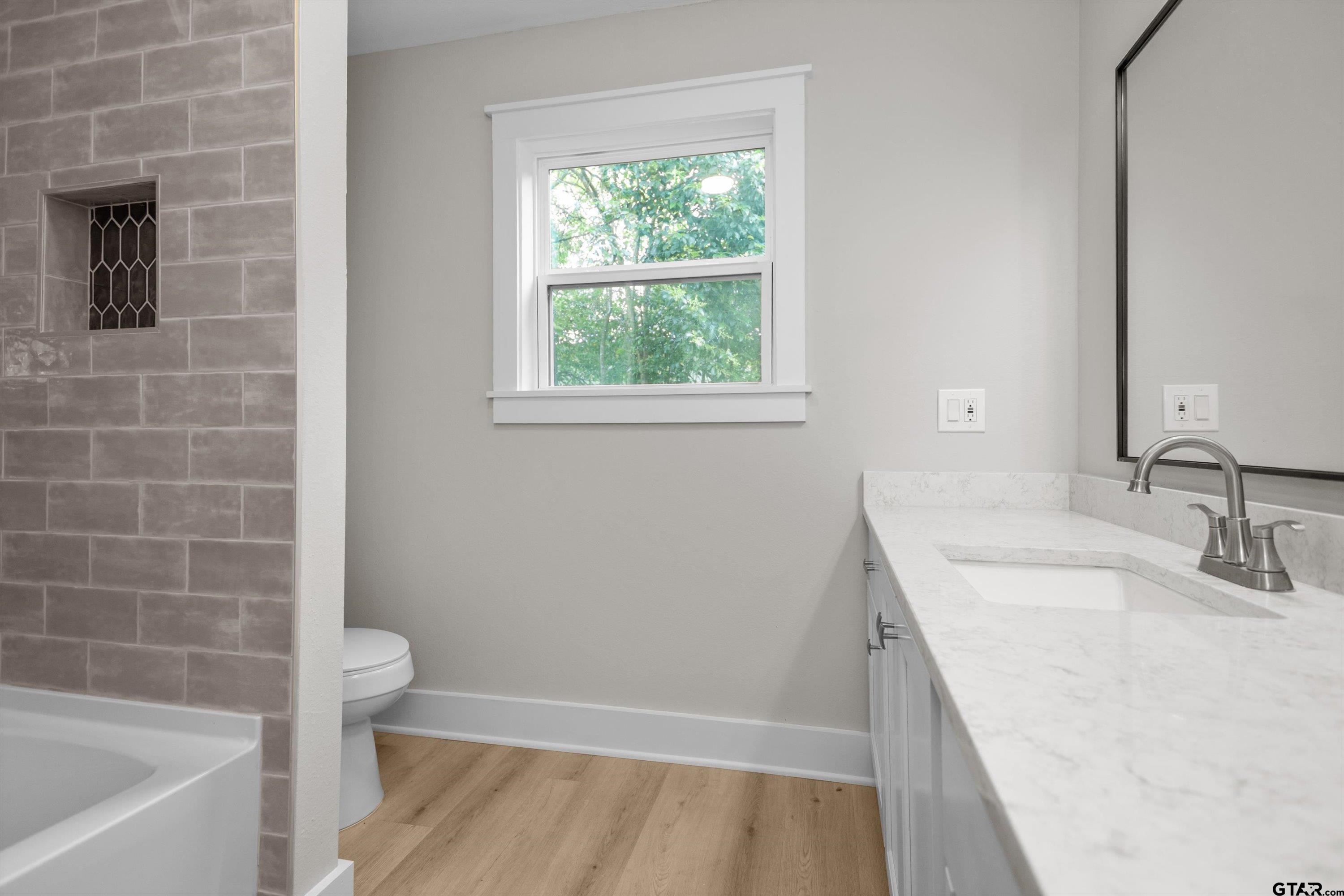601 North 4th Street Crockett, TX 75835 - Photo 17 of 25 a bathroom with a sink a toilet and shower