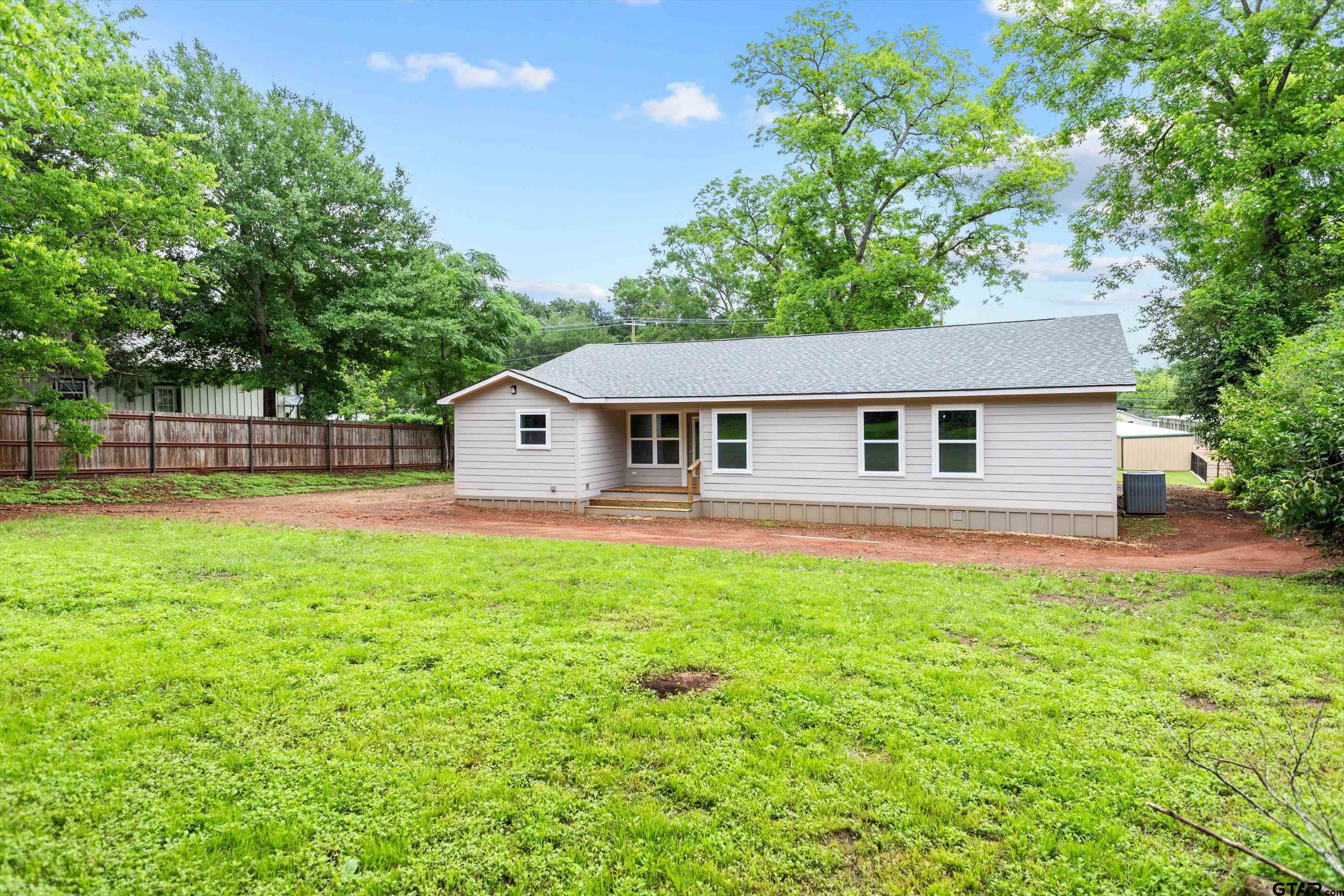 601 North 4th Street Crockett, TX 75835 - Photo 21 of 25 a front view of a house with garden