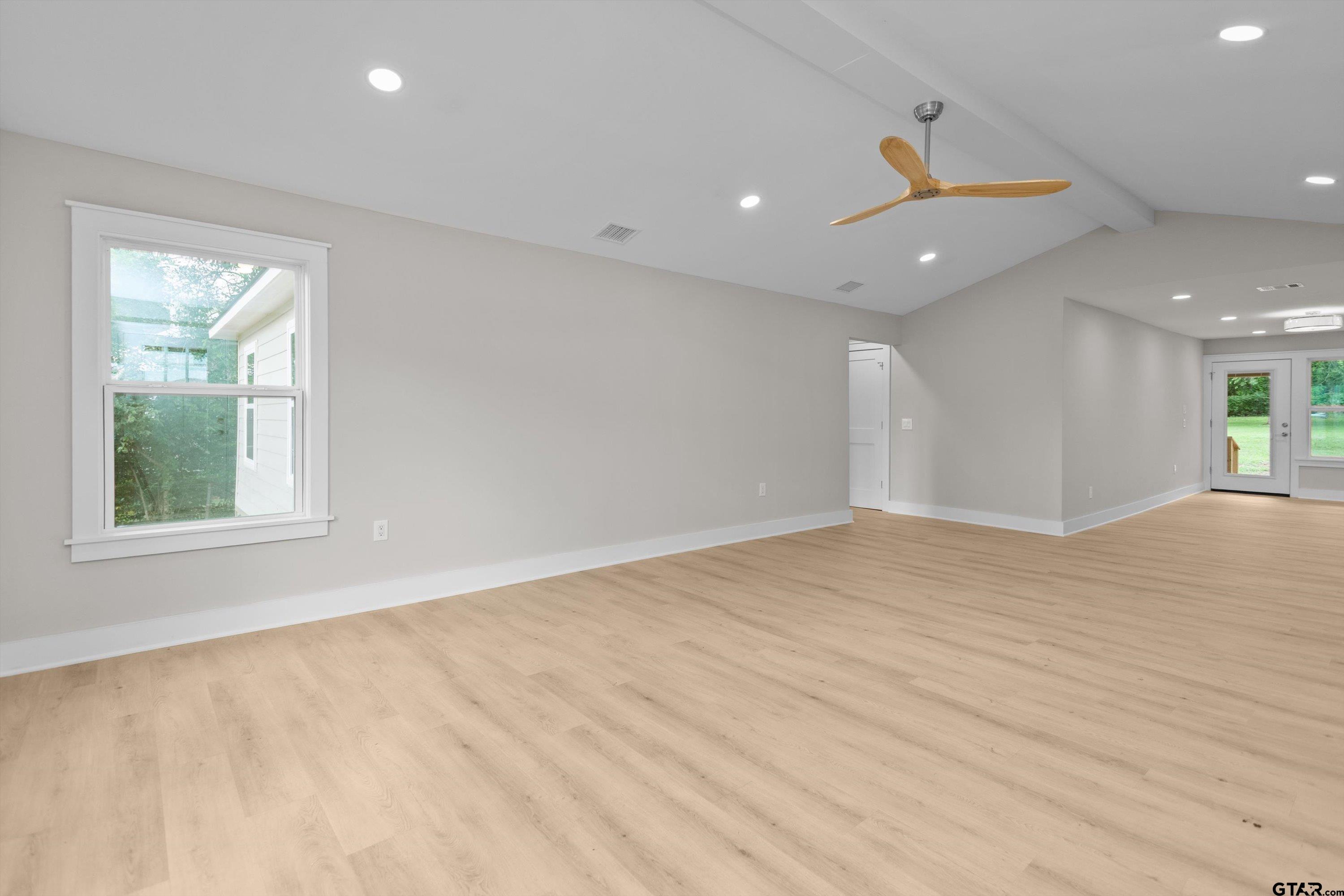601 North 4th Street Crockett, TX 75835 - Photo 24 of 25 an empty room with wooden floor and windows