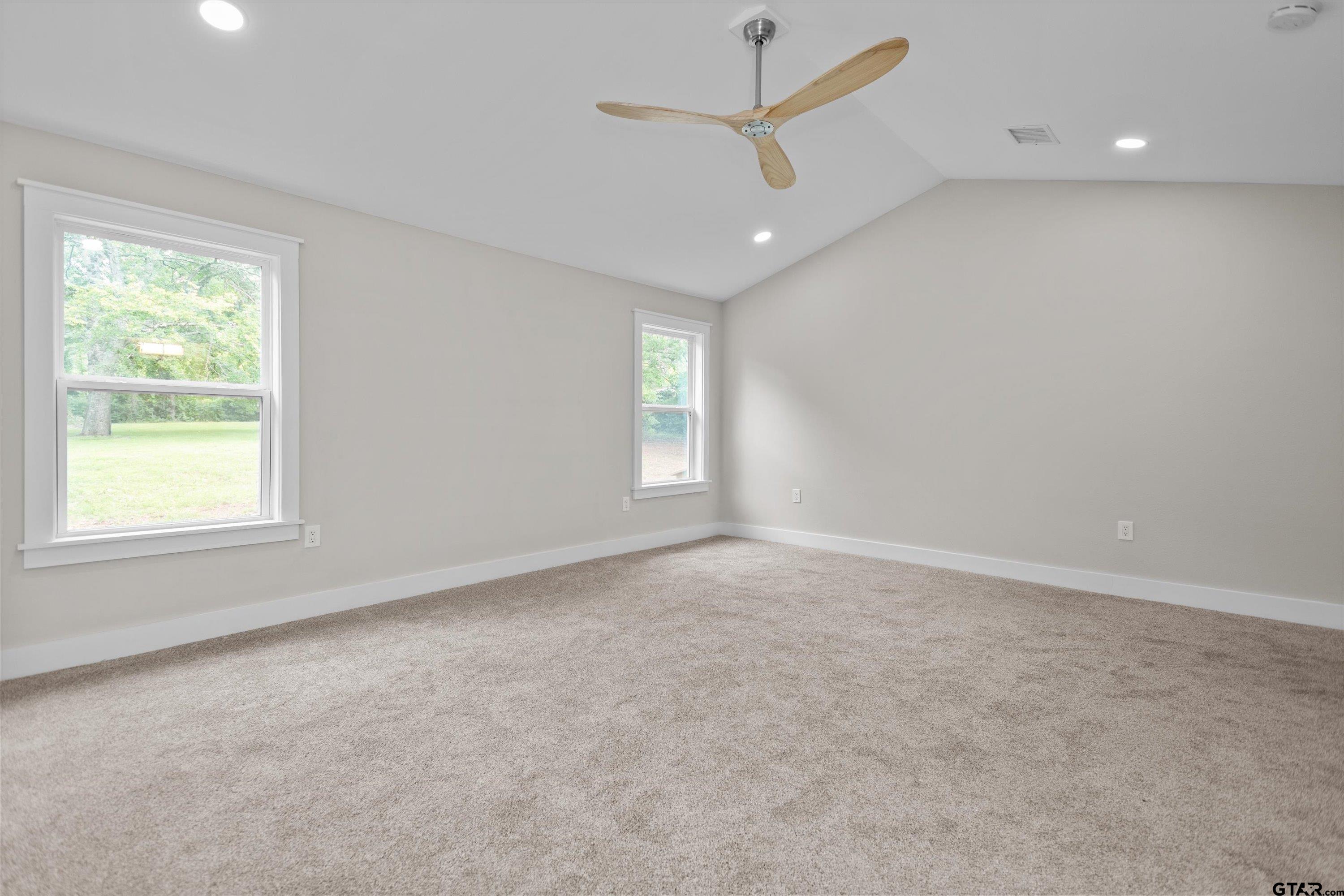 601 North 4th Street Crockett, TX 75835 - Photo 7 of 25 an empty room with a window and a ceiling fan