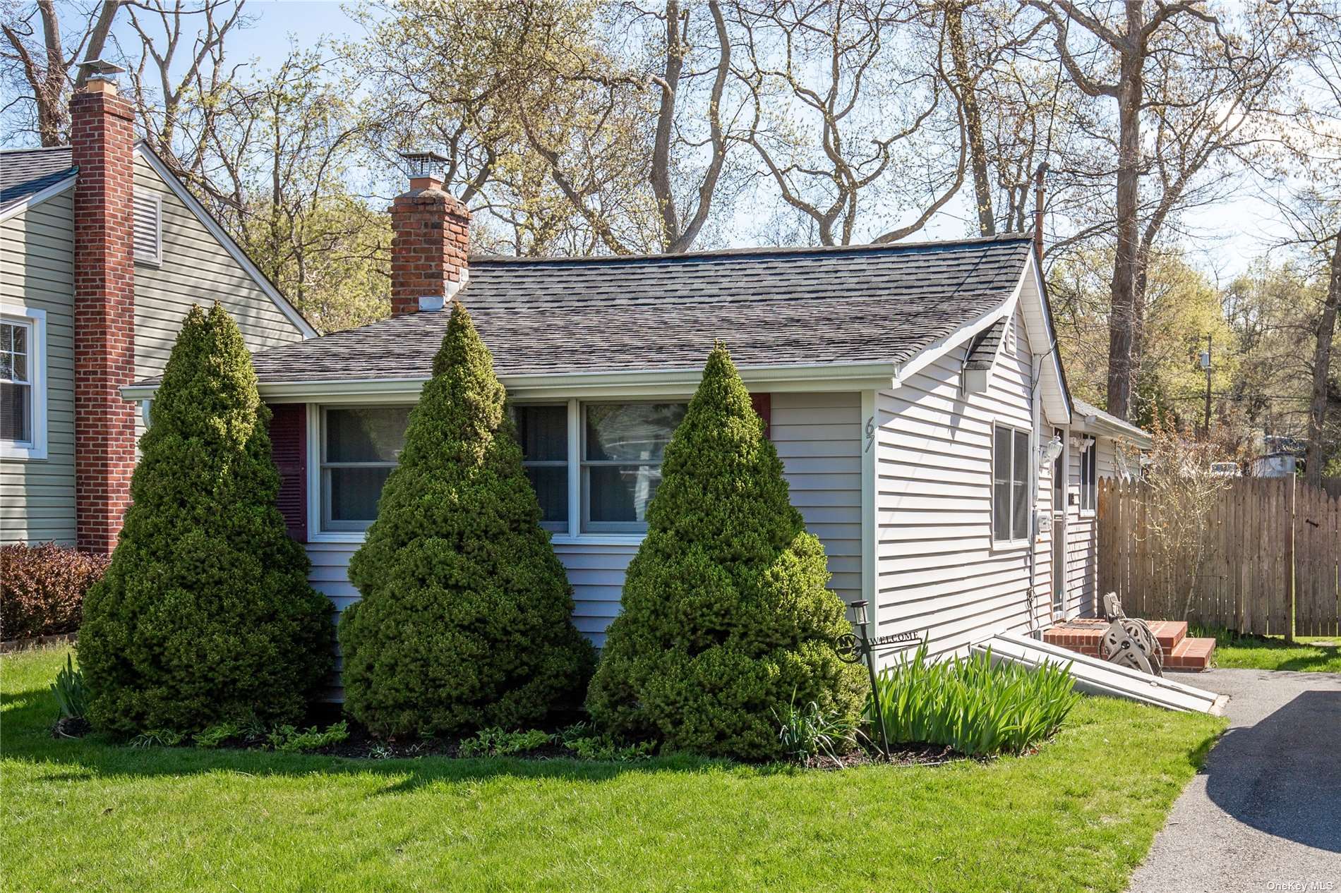 67 Quail Road Rocky Point, NY 11778 - Photo 1 of 1 a front view of a house with a yard and garage
