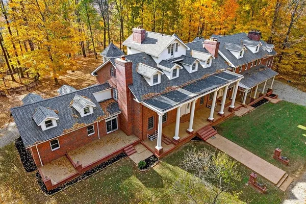 an aerial view of a house with a backyard