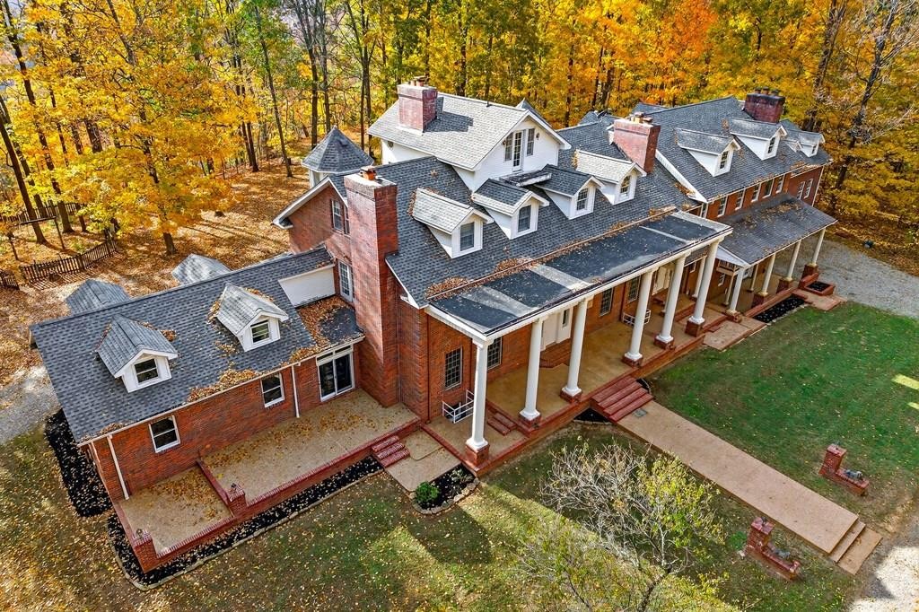 an aerial view of a house with a backyard