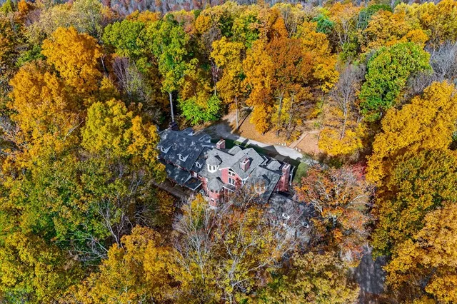 front view of a brick house with a yard