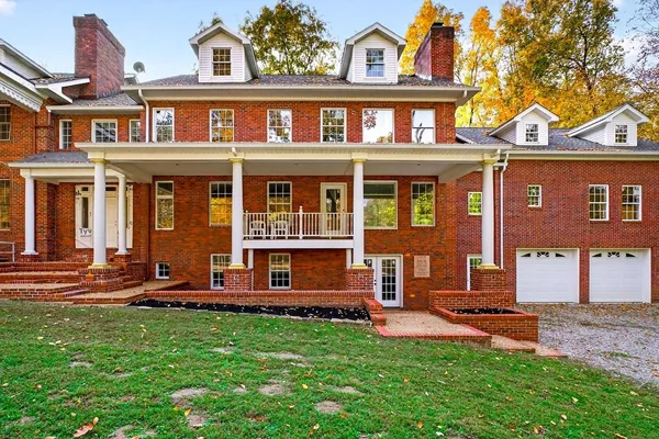 a view of staircase with a large window and a chandelier