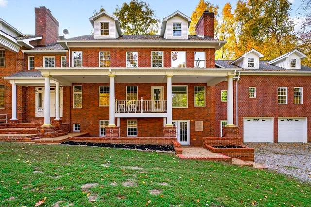 a view of staircase with a large window and a chandelier