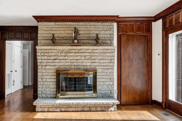 a view of a livingroom with a fireplace and windows