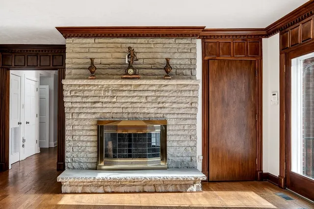 a view of a livingroom with a fireplace and windows