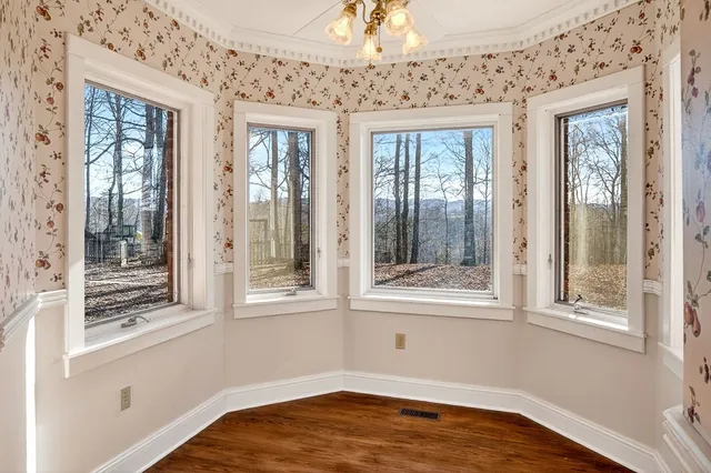 a view of a hall with wooden floor