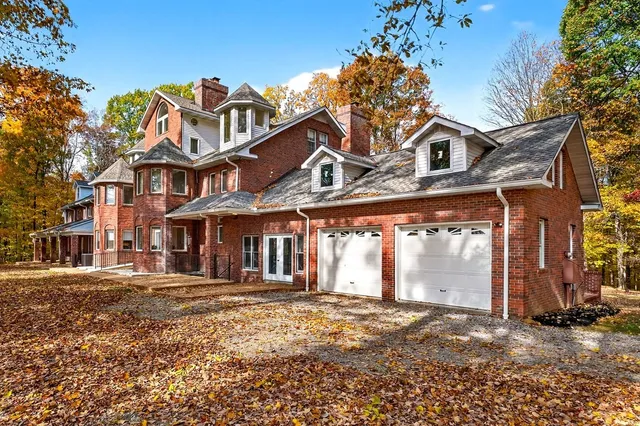 front view of a brick house with a yard