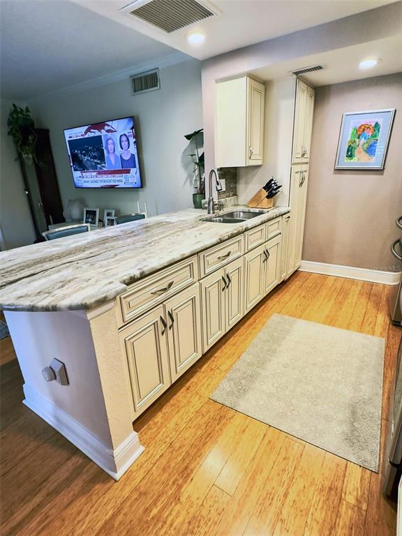8911 Blind Pass Road, Unit 220 St. Pete Beach, FL 33706 - Photo 54 of 67 a kitchen with stainless steel appliances granite countertop a stove a sink and a microwave