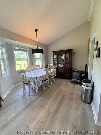 a dining room with furniture and window