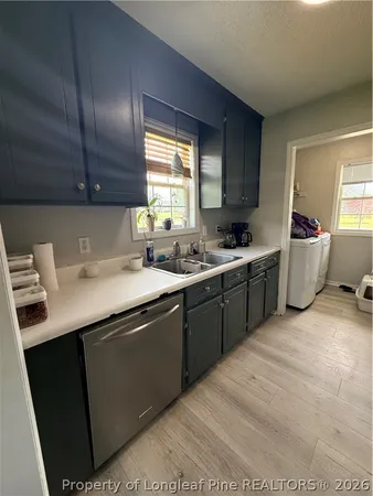 a kitchen that has a sink and a stove in it
