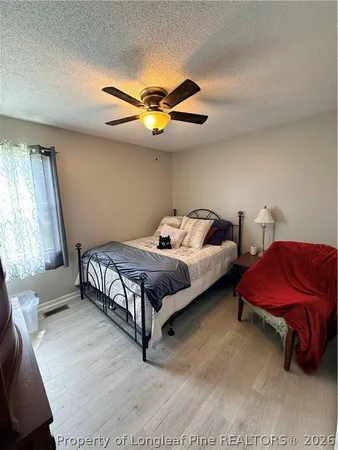 a bedroom with 2 bed and a window