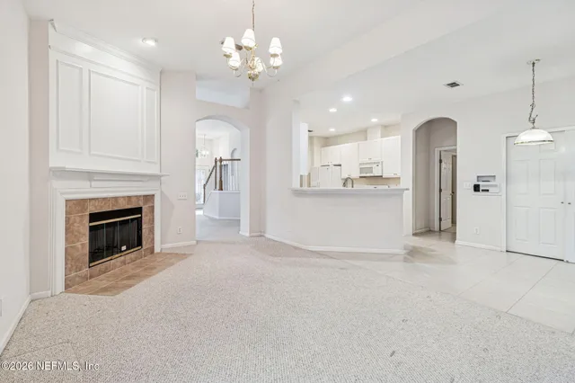 an empty room with a window and mirror