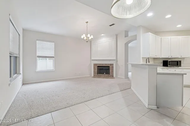 a view of a kitchen with refrigerator and a sink