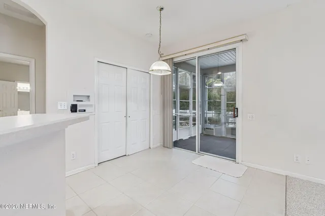 a kitchen with white cabinets a sink and appliances