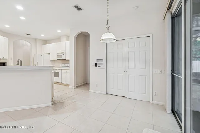 a kitchen with a sink dishwasher stove and cabinets