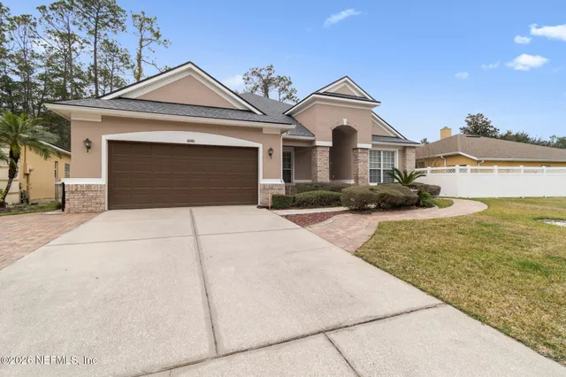 a front view of a house with a yard and garage