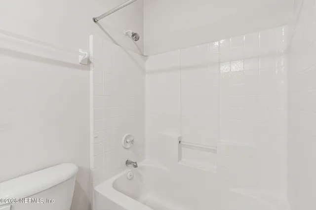 an aerial view of a house with swimming pool and a yard