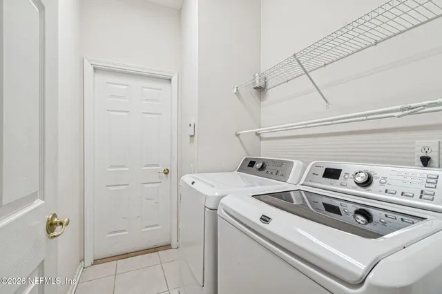 a aerial view of a house with swimming pool and green space