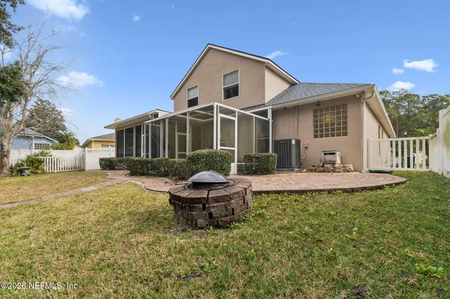 an aerial view of a house with a yard swimming pool and outdoor seating