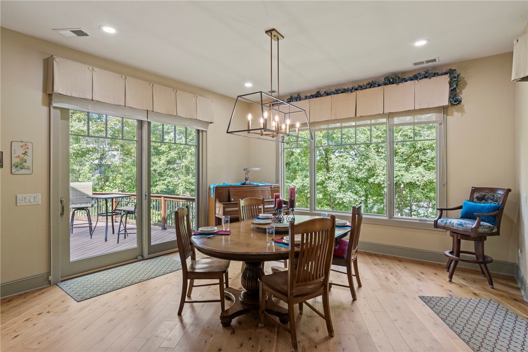 117 Sunrise Ridge Sunset, SC 29685 - Photo 8 of 44 Natural light floods this dining area, featuring beautiful hardwood flooring and a charming deck access.