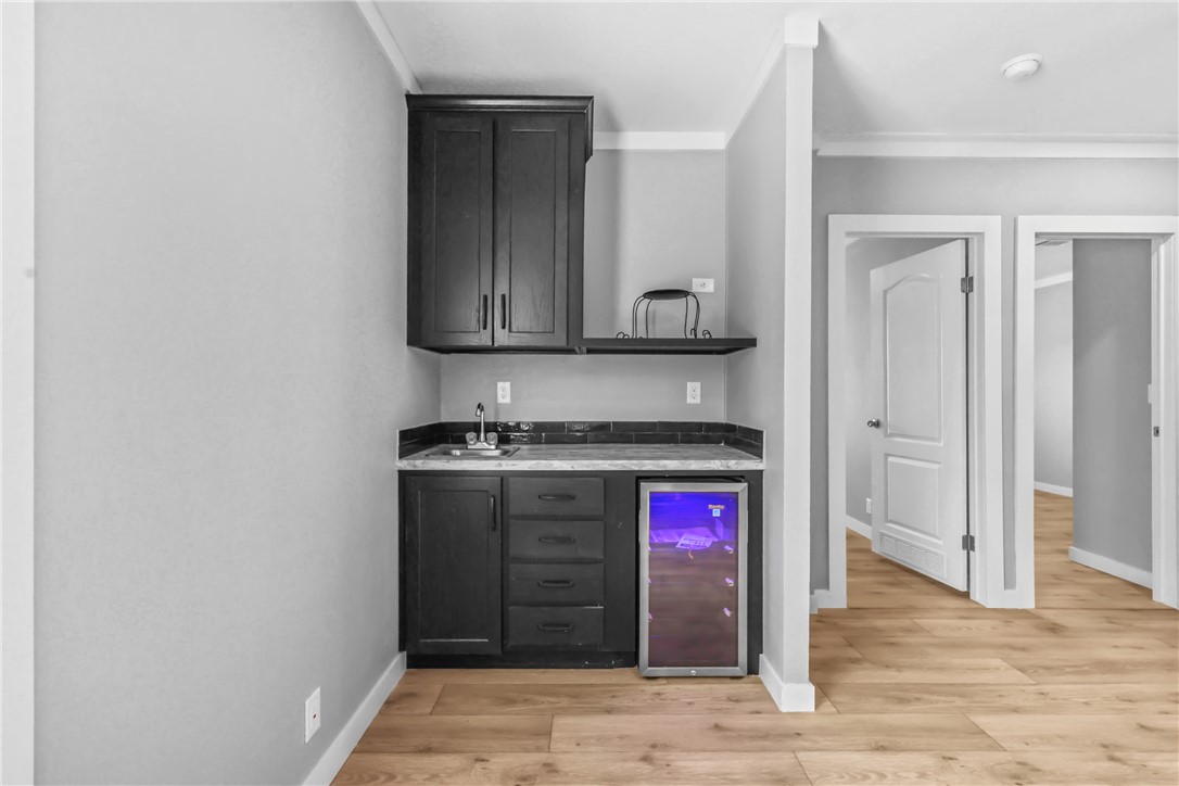 12796 South Fork Road Iola, TX 77861 - Photo 14 of 28 Indoor wet bar featuring beverage, sink, cabinet, microwave area