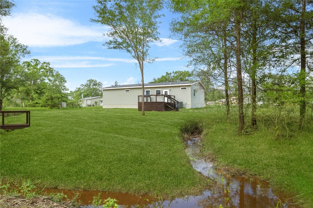12796 South Fork Road Iola, TX 77861 - Photo 25 of 28 Back yard view of back of house and portion of creek