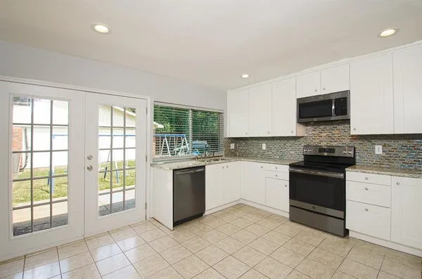 a kitchen with microwave stove and cabinets