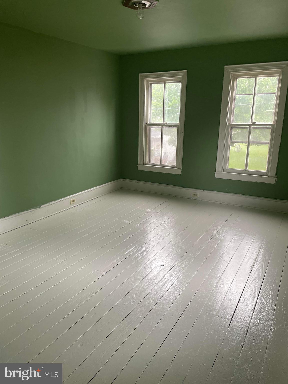 60 West 3rd Street Pottstown, PA 19464 - Photo 2 of 13 an empty room with wooden floor and windows