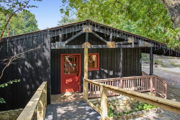 a view of a house with backyard sitting area and garden