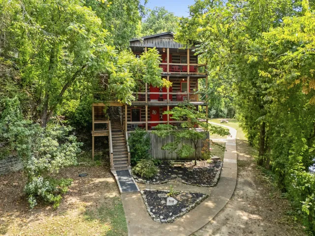 a view of a field with an ocean and trees
