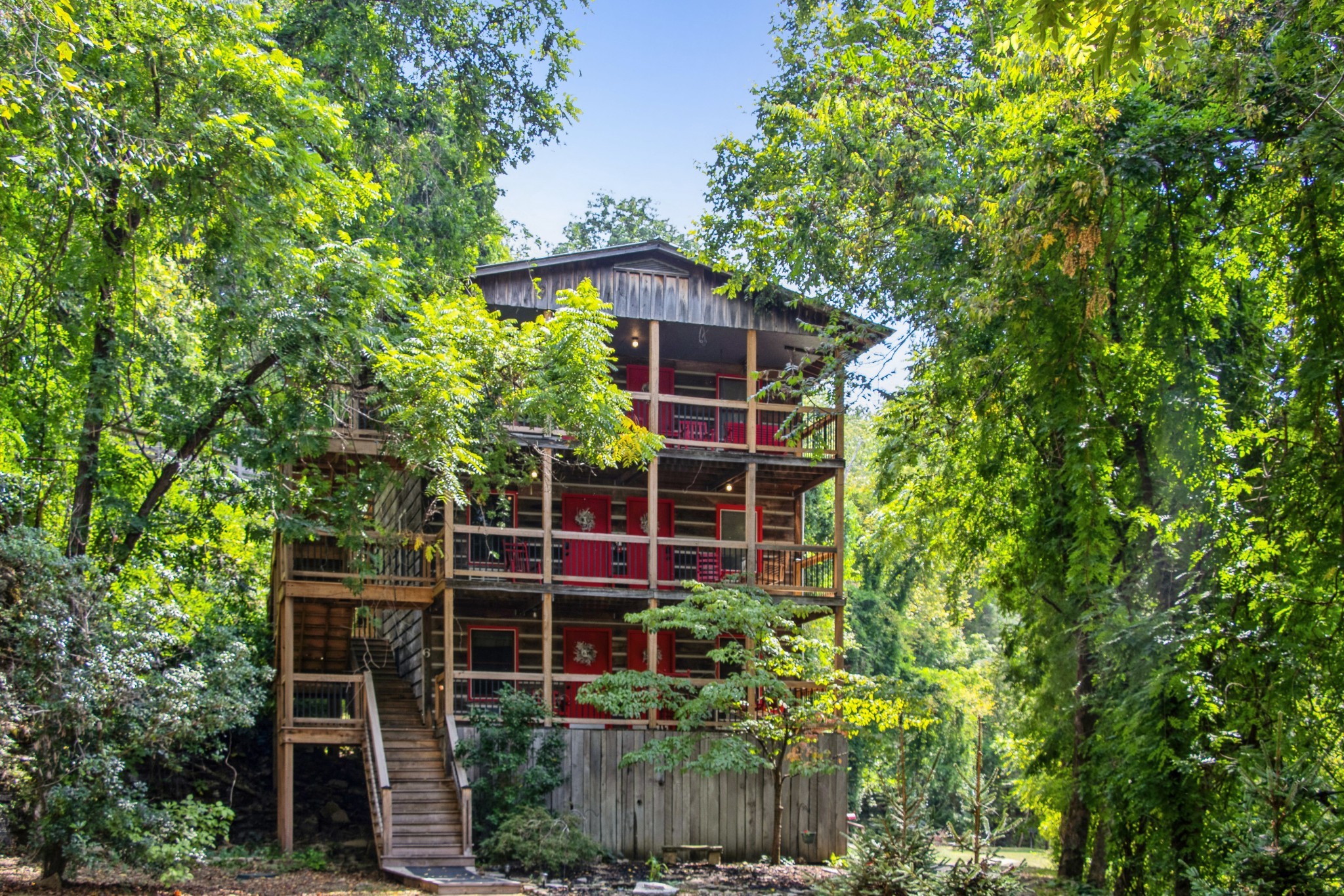 299 Natural Bridge Park Road Waynesboro, TN 38485 - Photo 47 of 63 a view of a house with a tree and flower plants