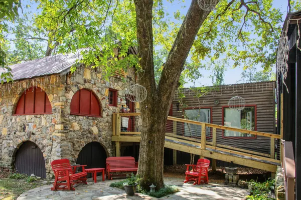 a view of a house with a wooden deck and a yard