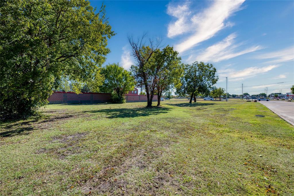2401 Arapaho Road Garland, TX 75044 - Photo 5 of 15 a view of a field with grass and trees