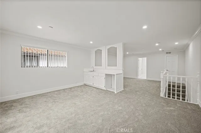 a view of a building with a yard and sitting area