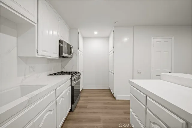 a kitchen with a sink stove and refrigerator
