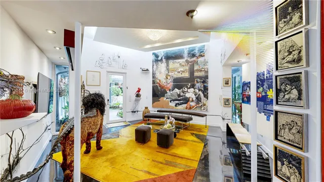 a living room with lots of furniture and a book shelf