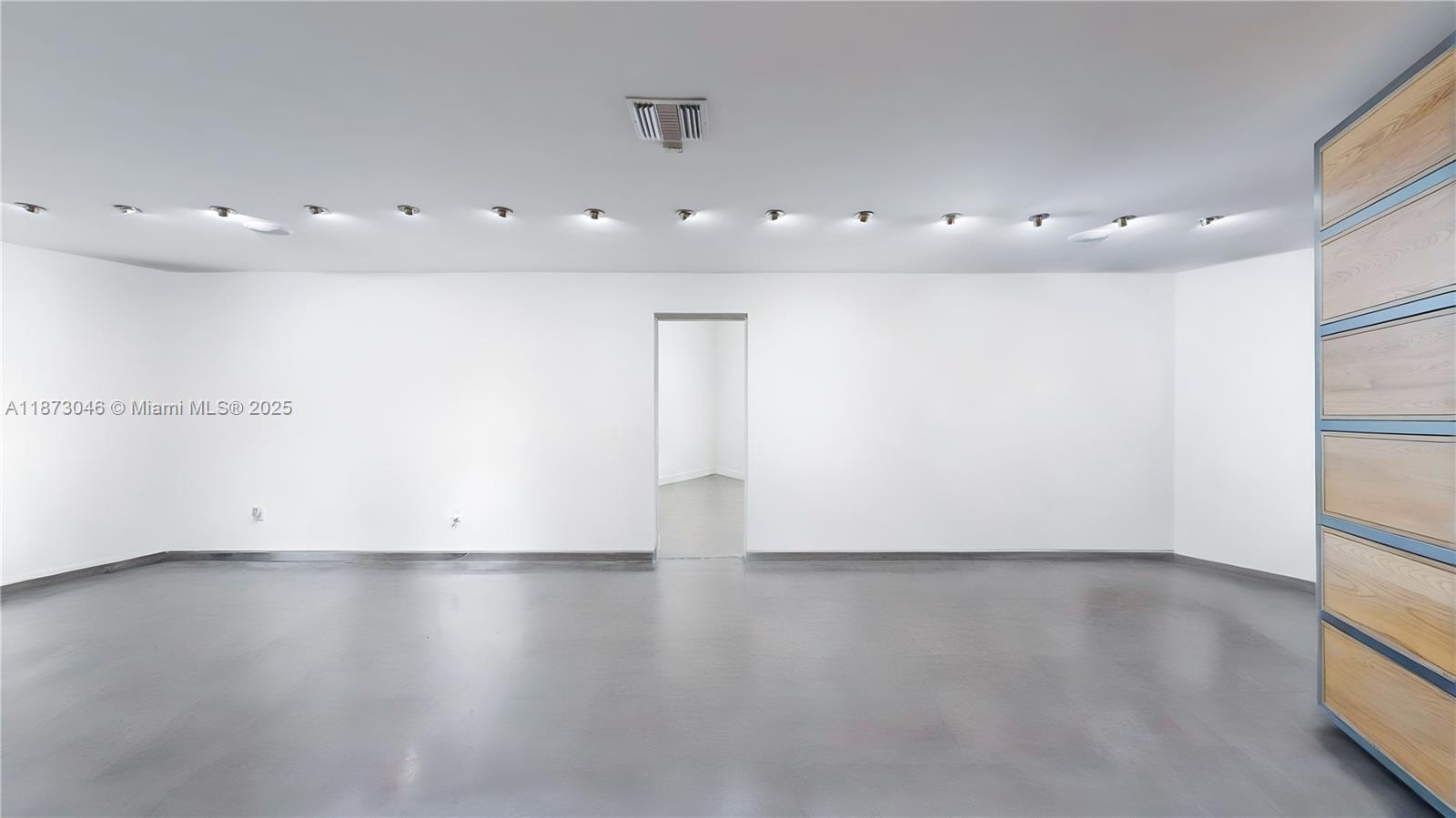 2101 Tigertail Avenue Miami, FL 33133 - Photo 23 of 92 an empty room with wooden floor and windows